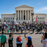 Protesters outside the U.S. Supreme Court hold signs supporting birthright citizenship.