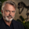 AI-generated editorial portrait of Sam Neill with a dinosaur skeleton in the background.
