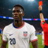 Folarin Balogun reacts after receiving a red card during the USA vs Bosnia World Cup match, leading to his suspension for the Belgium game.
